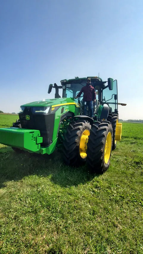 Anwar beside a tractor